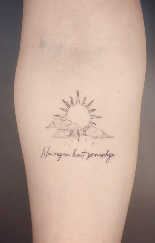 Delicate sun and cloud tattoo with rain and Dutch phrase.