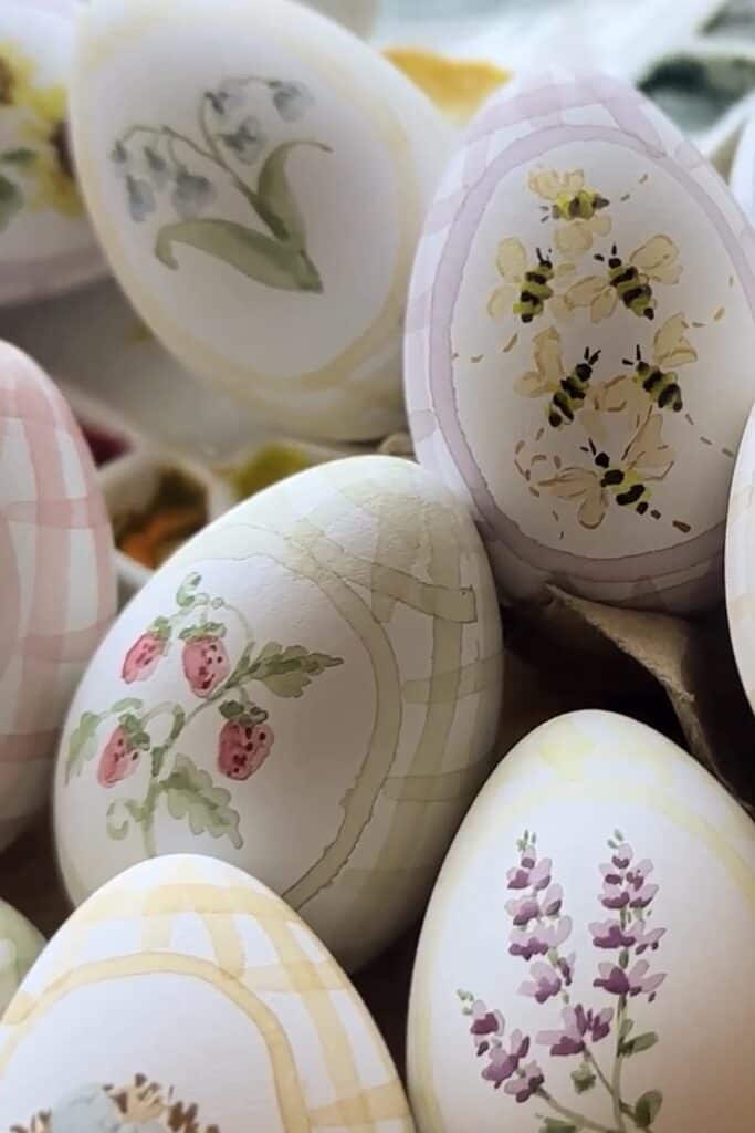 Vivid Easter eggs decorated with flowers, berries, and bees for spring celebrations.