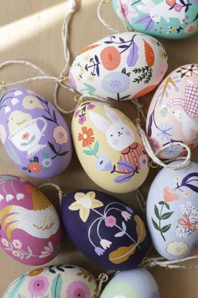 Colorful painted eggs featuring floral, animal, and abstract patterns for spring decor.