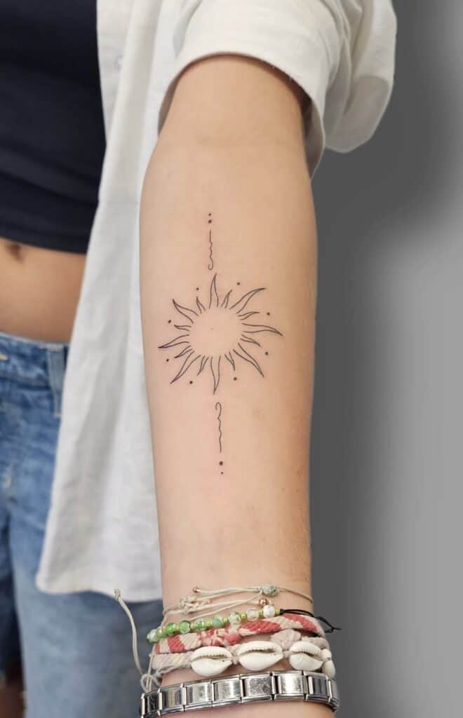 Minimalist black ink sun and moon tattoo art on arm, body art design inspiration.
