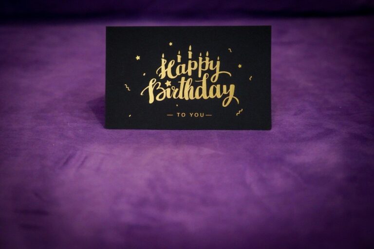 Handcrafted black birthday card with gold lettering and festive decorations.