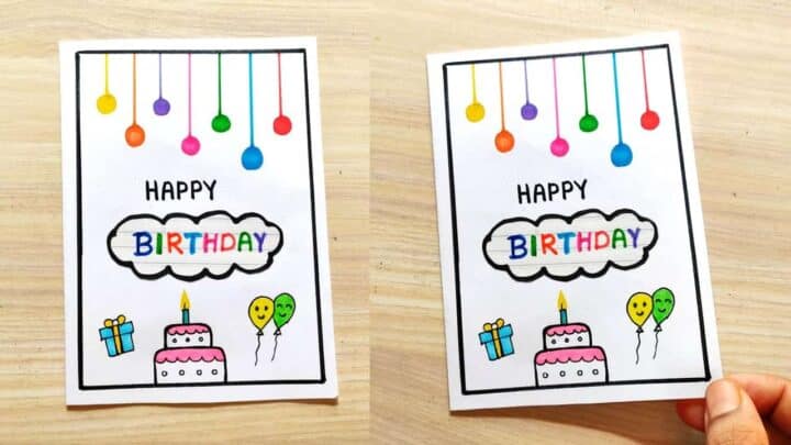 Hand holding a birthday card with balloons, cake, and presents for celebration.