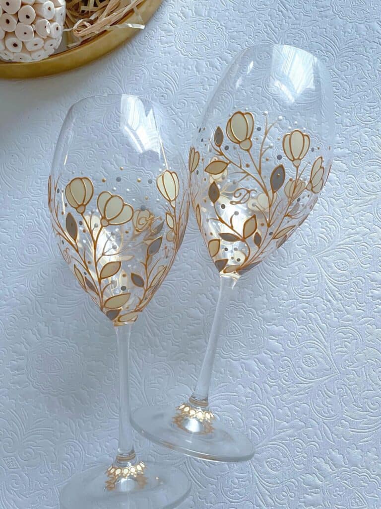 Beautiful hand-painted floral wine glasses with gold accents for celebrations.