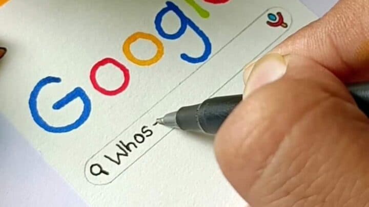 Hand drawing Google logo on a birthday card with a pen, DIY craft idea.