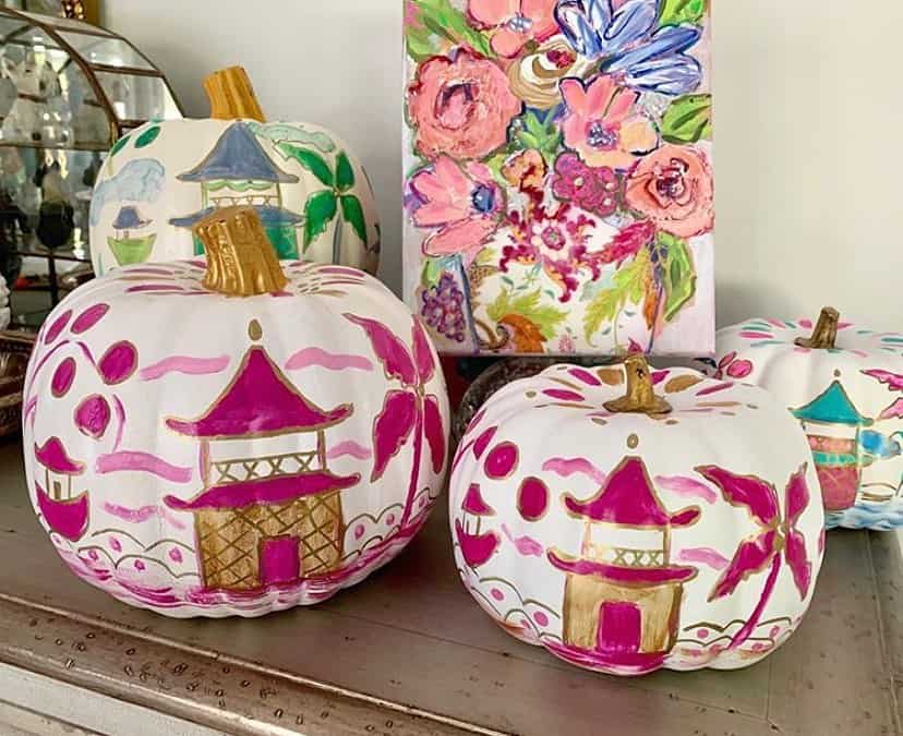 Colorful painted pumpkins with pink, gold, and teal accents for fall decor.