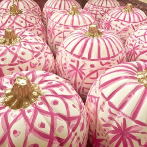 Decorative pink pumpkins with gold stems for fall or Halloween.
