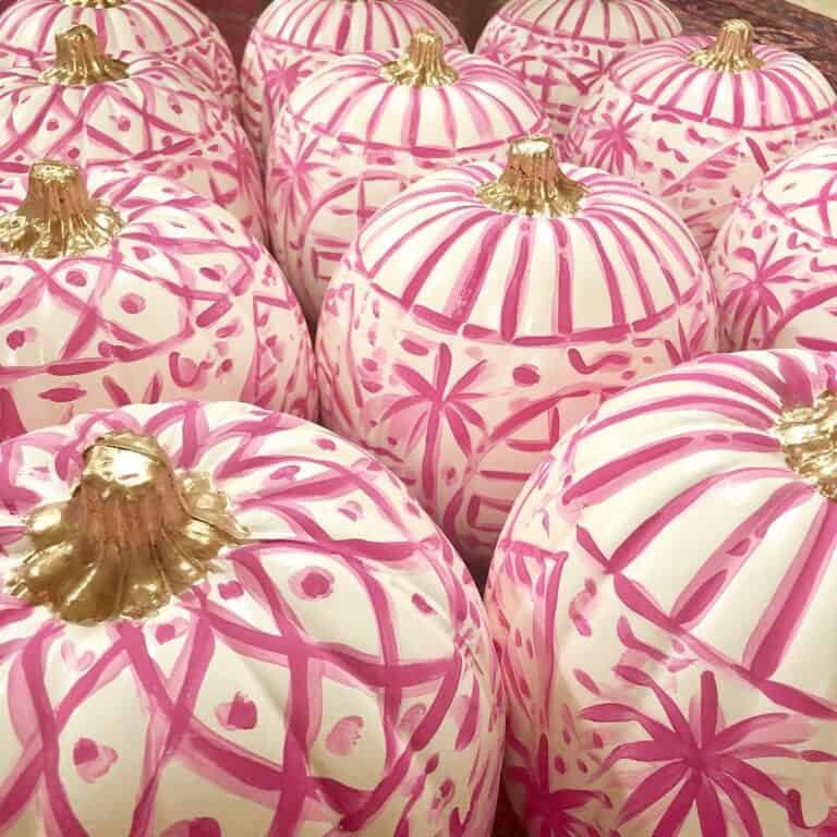 Decorative pink pumpkins with gold stems for fall or Halloween.